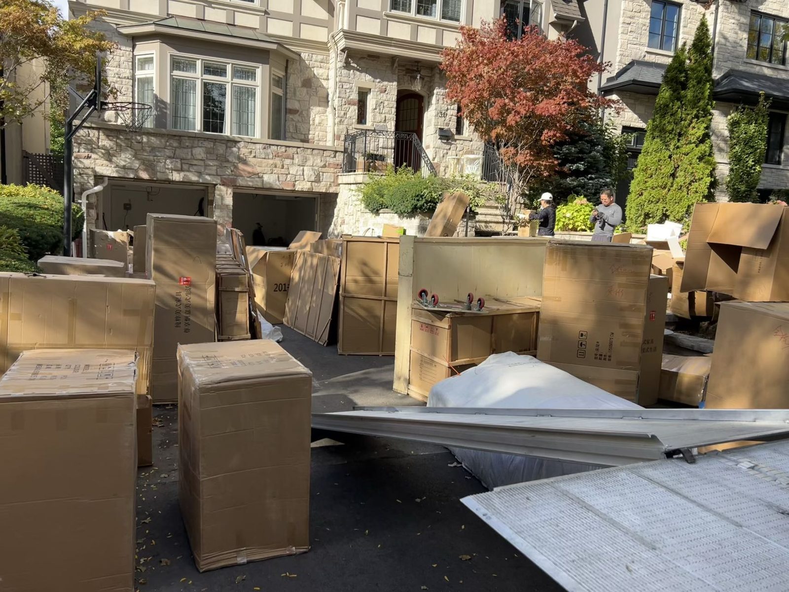 Large volume of crated furniture delivered to a detached home driveway in the GTA