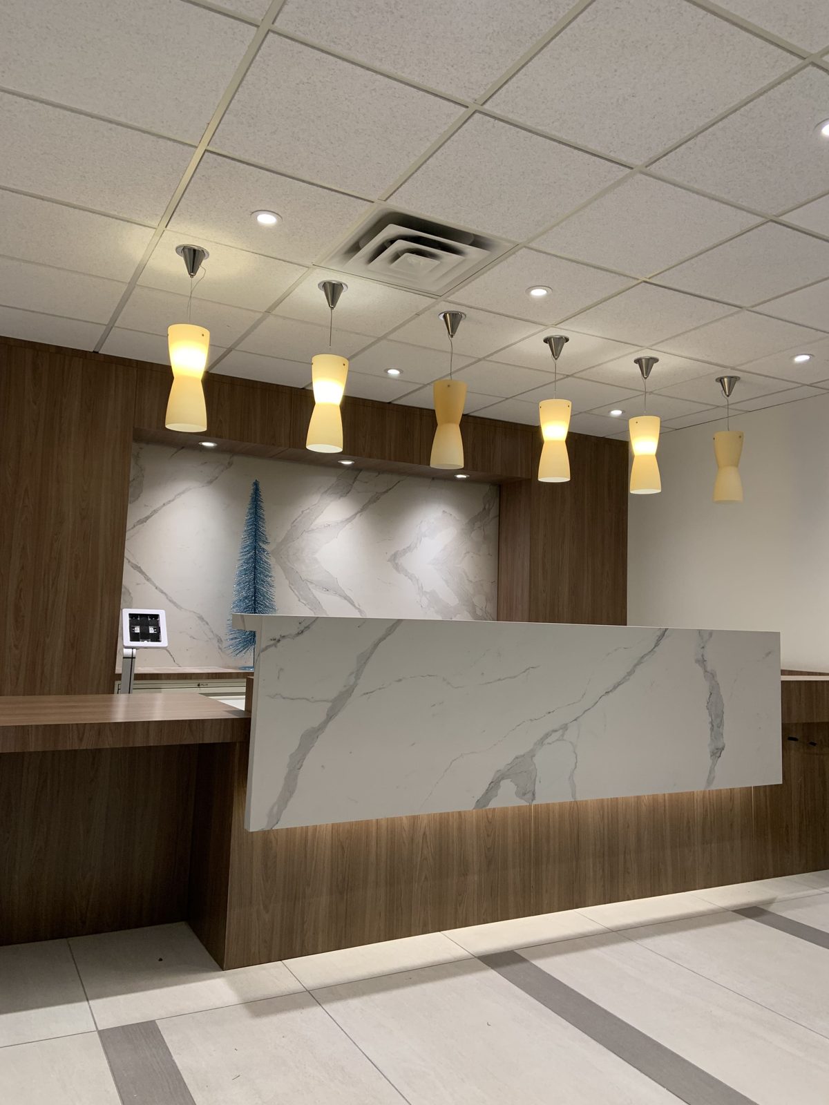 Reception counter and lobby lighting in place after an office relocation