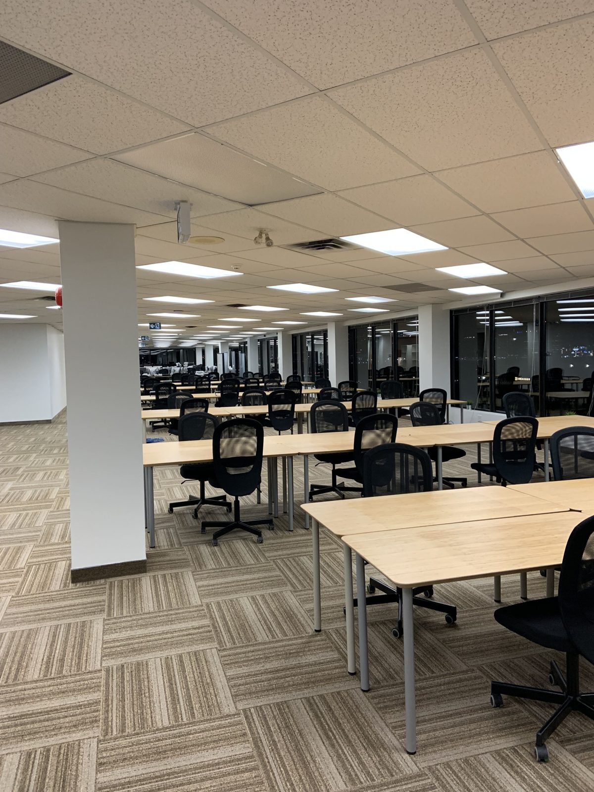 Open plan office with workstations and task chairs before a Toronto office relocation