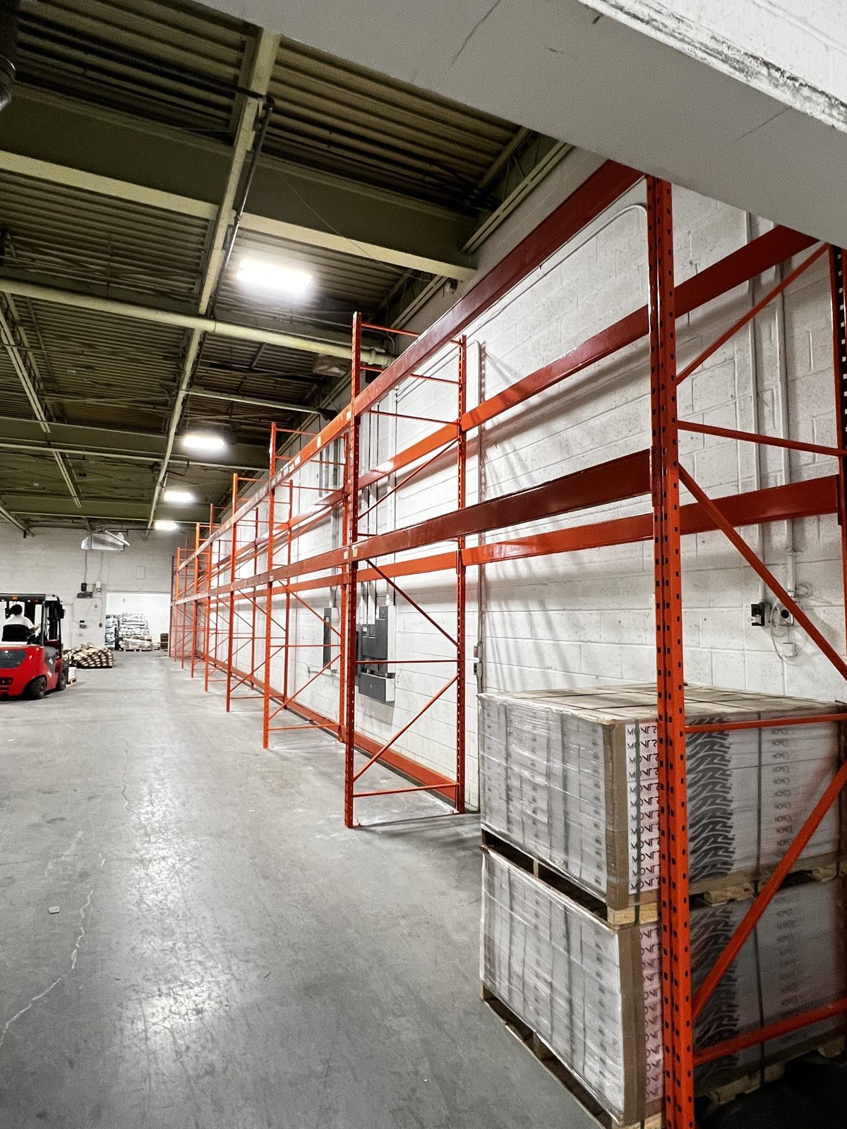 Installed warehouse pallet racking loaded with palletised stock